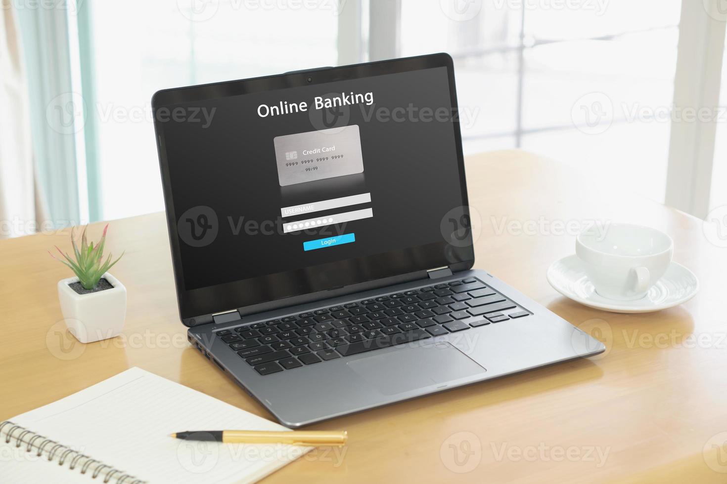 Laptop computer on wood table opening online internet banking photo