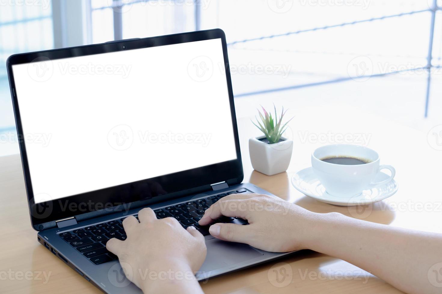 Businessman working on laptop computer with empty white screen photo