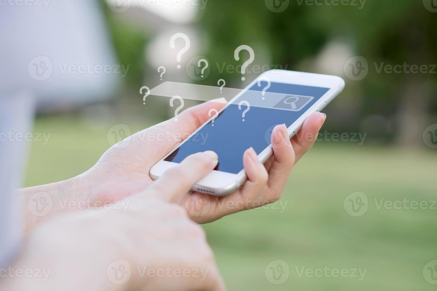 Hands of woman with smartphone searching and big data concepts in the garden photo