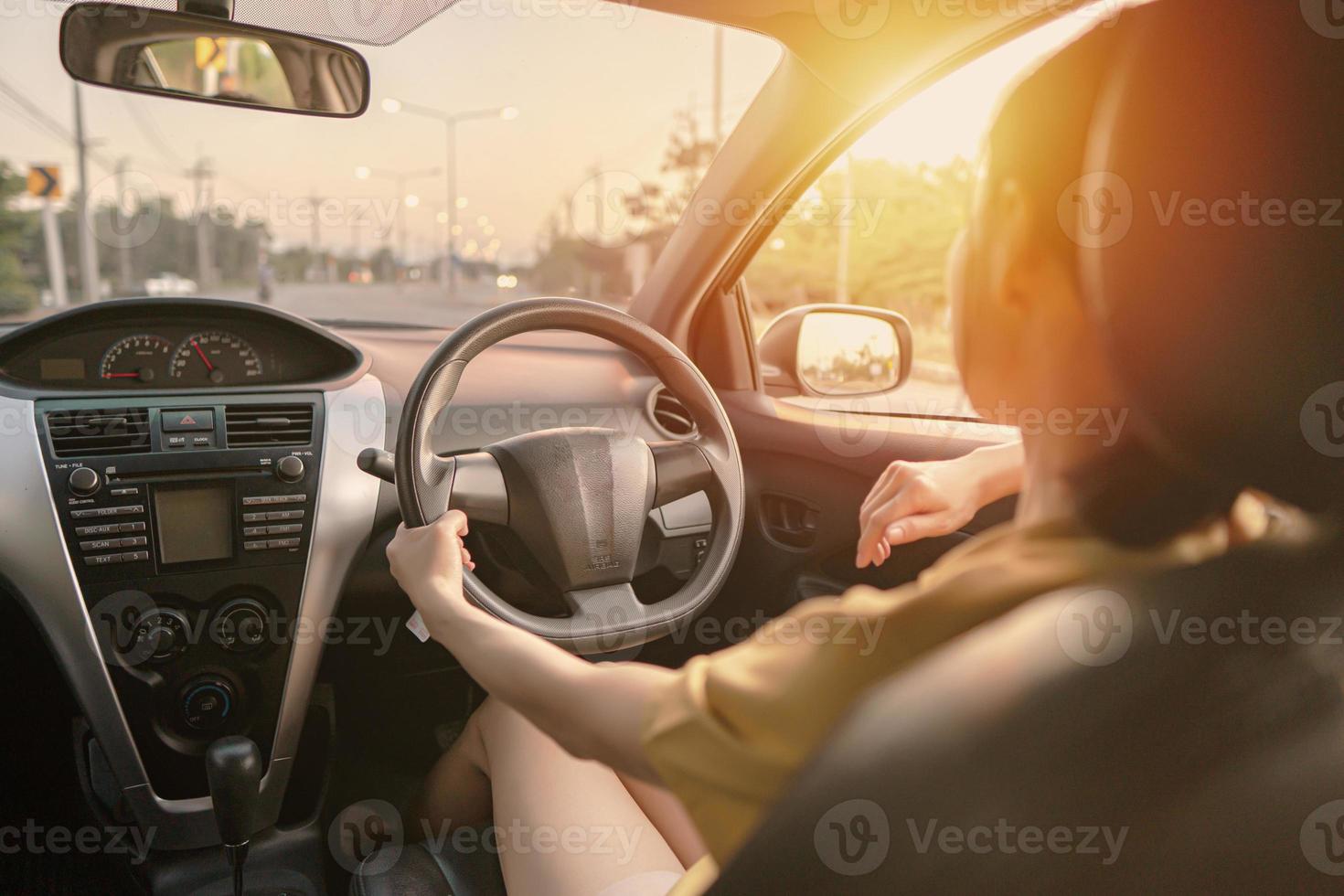 Rear view of cool woman in driving car photo