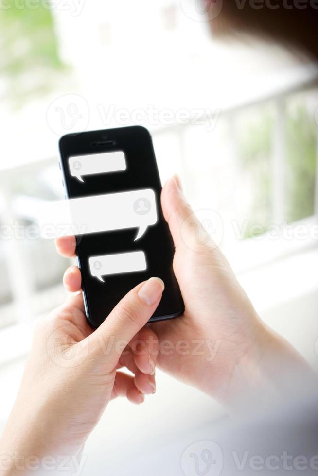 Hand of woman typing text on mobile smartphone. Online live chat chatting on application photo