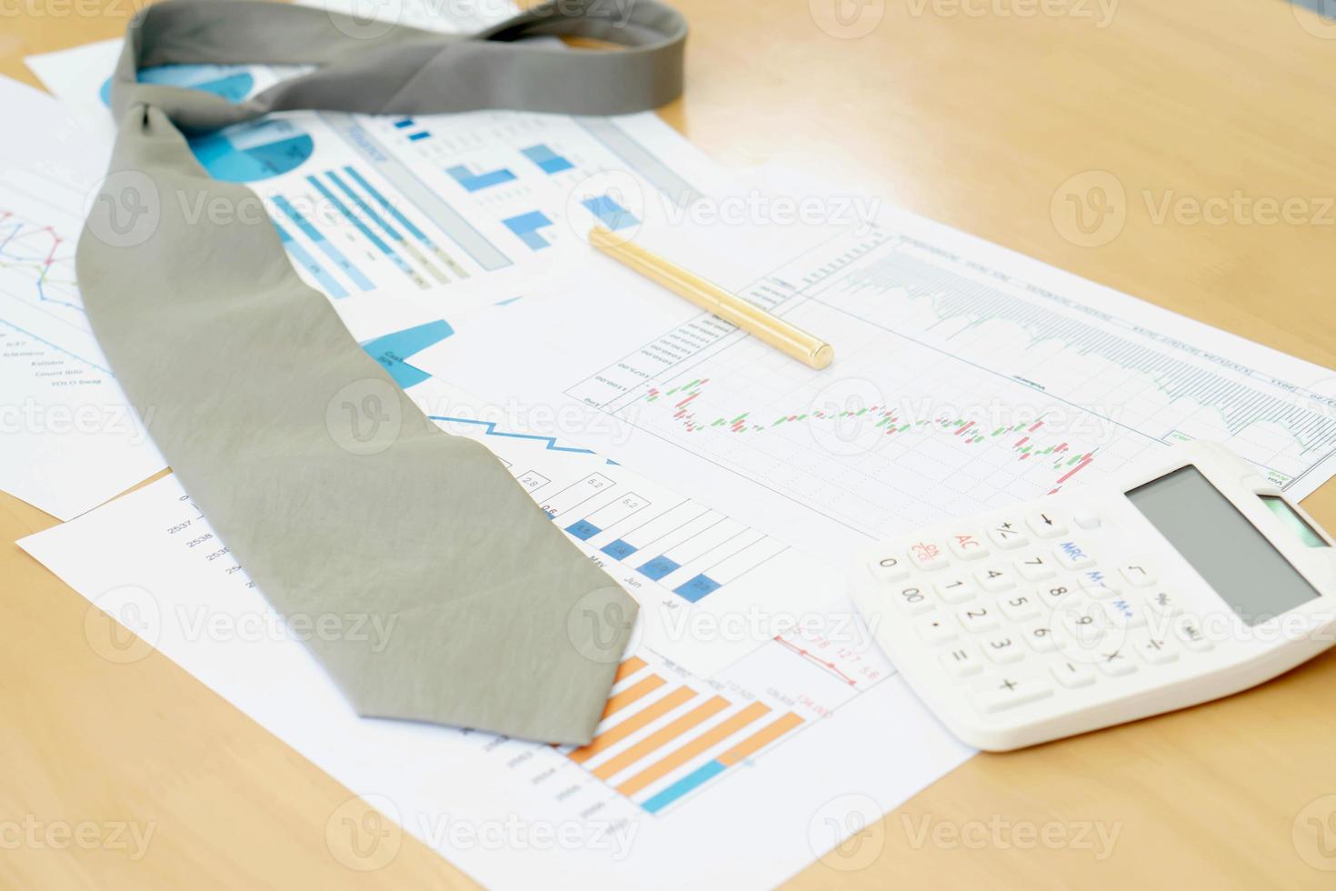 Necktie Graphs Calculator and Pen. Finance Concept photo