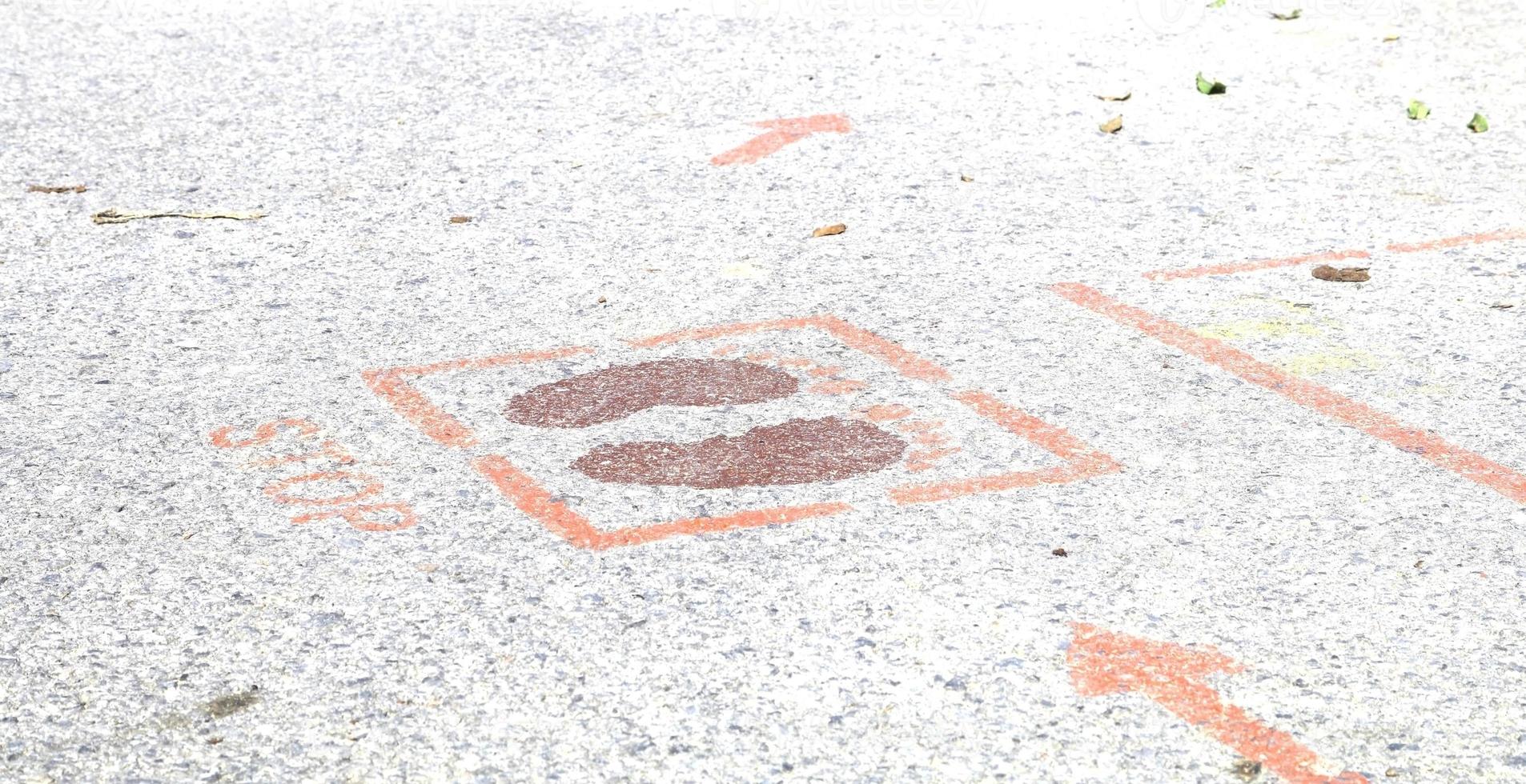 Foot symbols on the ground tell people to keep people 6 feet apart during the coronavirus outbreak in many countries around the world and common filtering points. photo