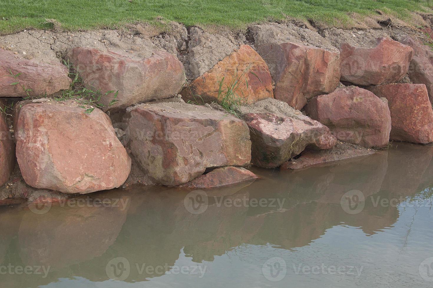 Brown stone with large patterns that are designed to be like nature by heavy machinery, beautifully crafted in a vast lakeside garden, perfect for relaxing and watching nature in summer and winter. photo