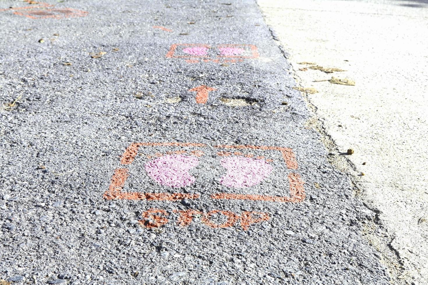 Foot symbols on the ground tell people to keep people 6 feet apart during the coronavirus outbreak in many countries around the world and common filtering points. photo