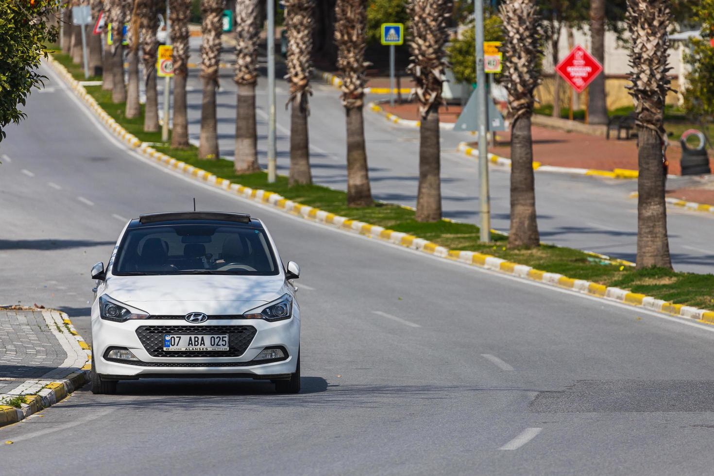Side Turkey  February 28 2022  white  Hyundai i20  is parking  on the street on a  summer day photo