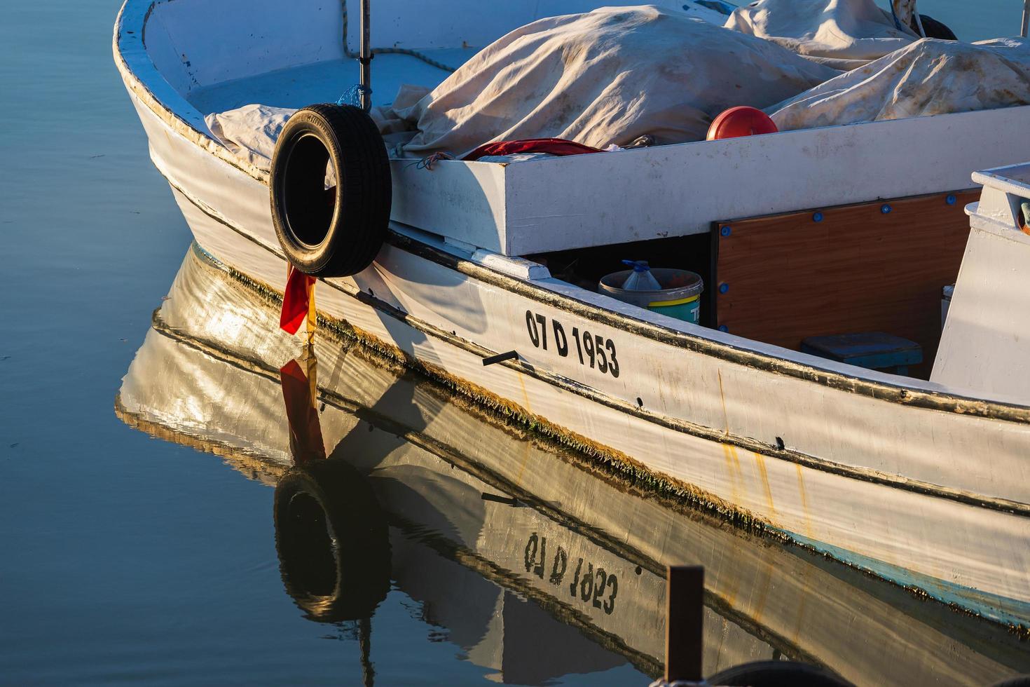 Side Turkey  February 20 2022  Wooden side of the  white boat with a  ropes against the background of sea water photo