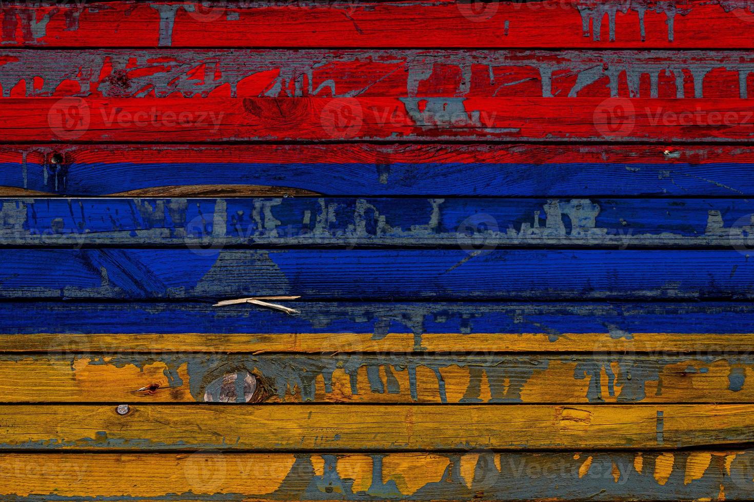 The national flag of Armenia is painted on uneven boards. Country symbol. photo