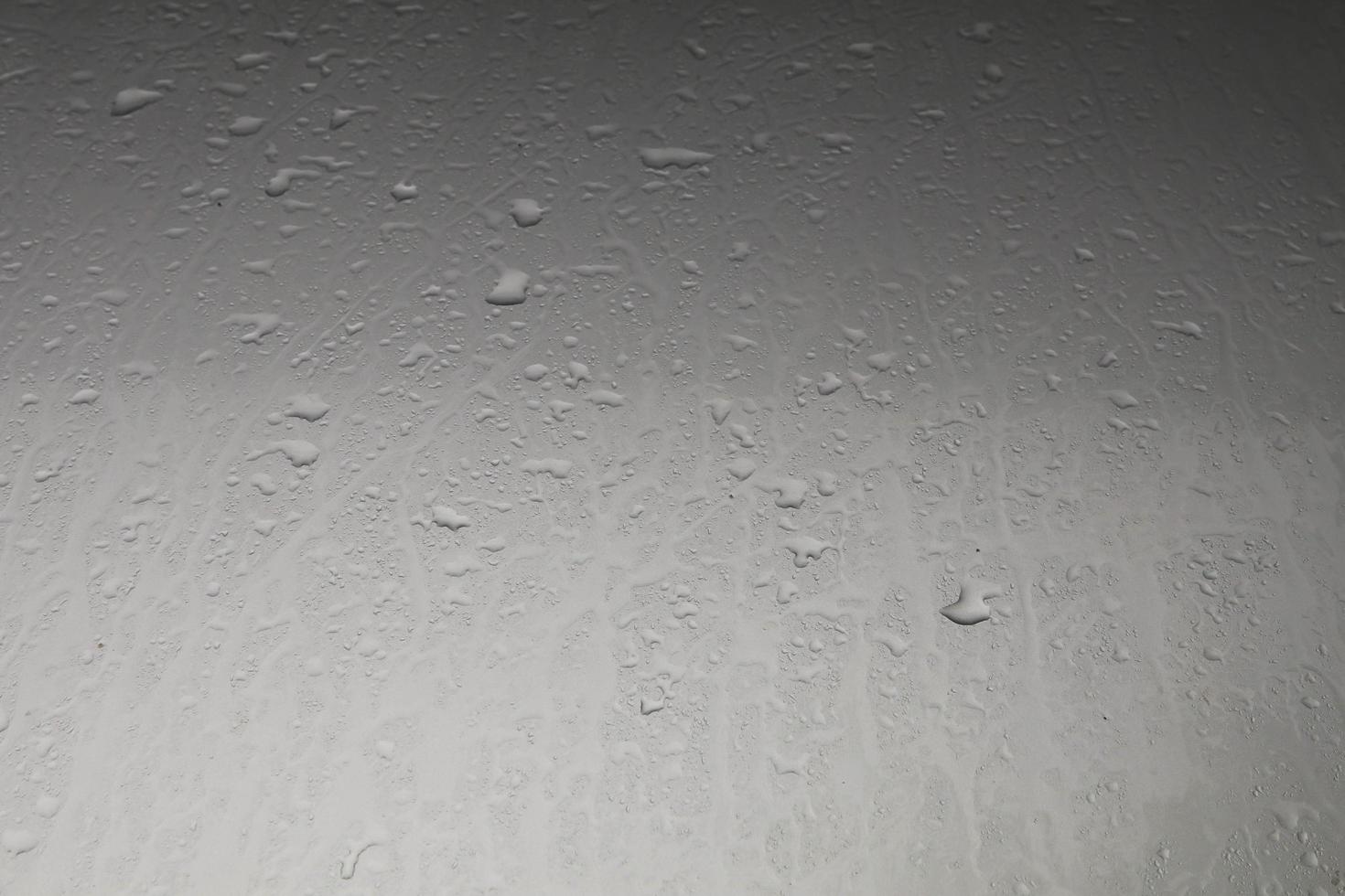 Water droplets on the hood after rain on a stormy day reflected in the gloomy sun all day on warm cold evenings. Quiet and lonely, scary photo
