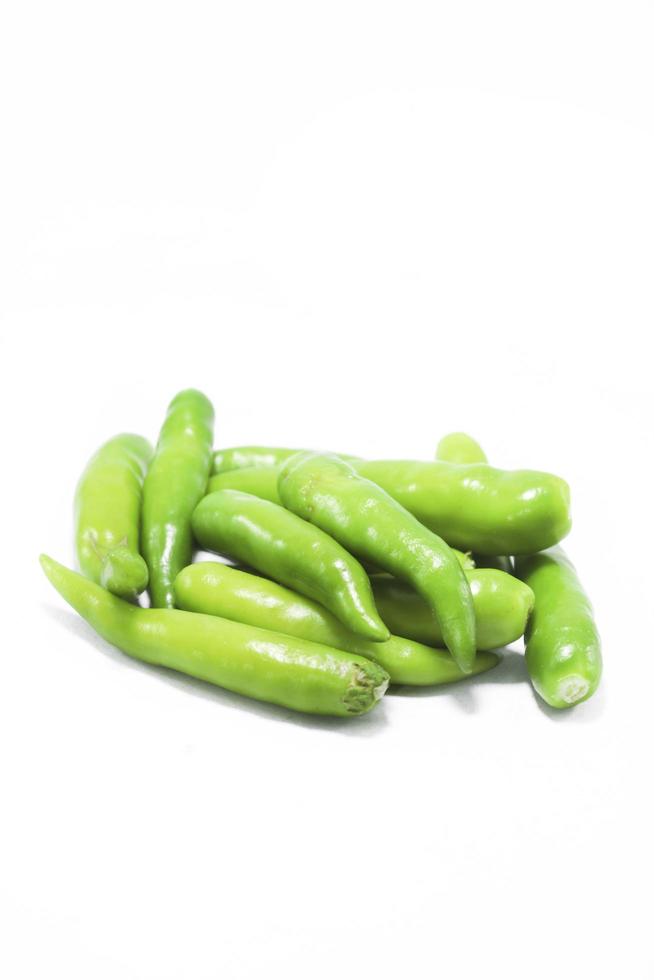 Fresh large green chillies cultivated by farmers for sale and self-eating - for seasoning and appetizing food on a white background with local hot letters. photo