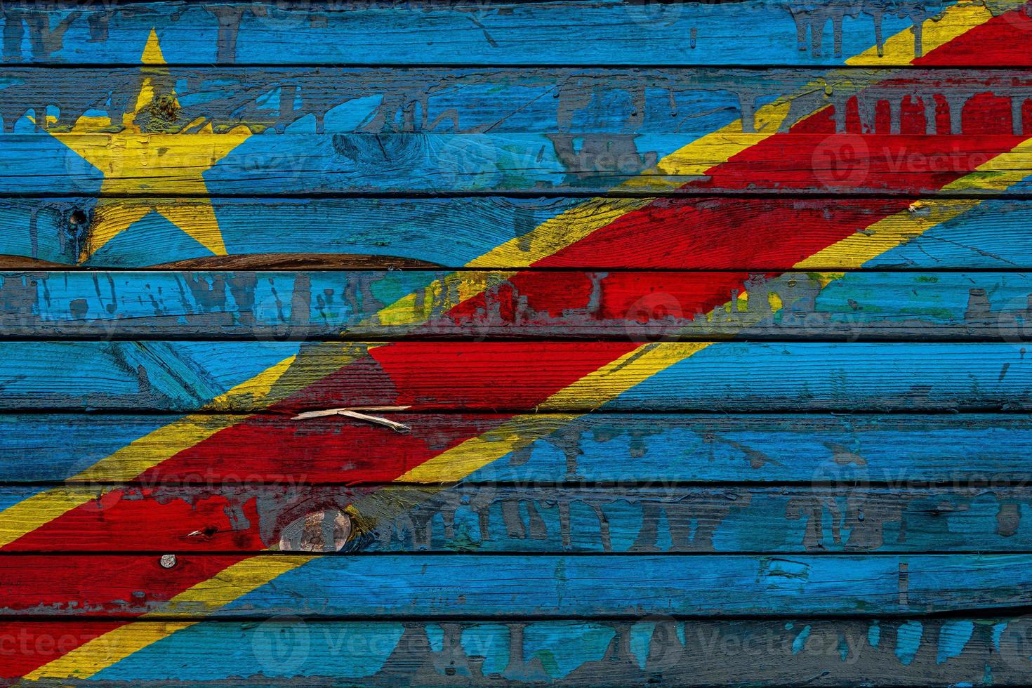 The national flag of Democratic Republic of the Congo is painted on uneven boards. Country symbol. photo