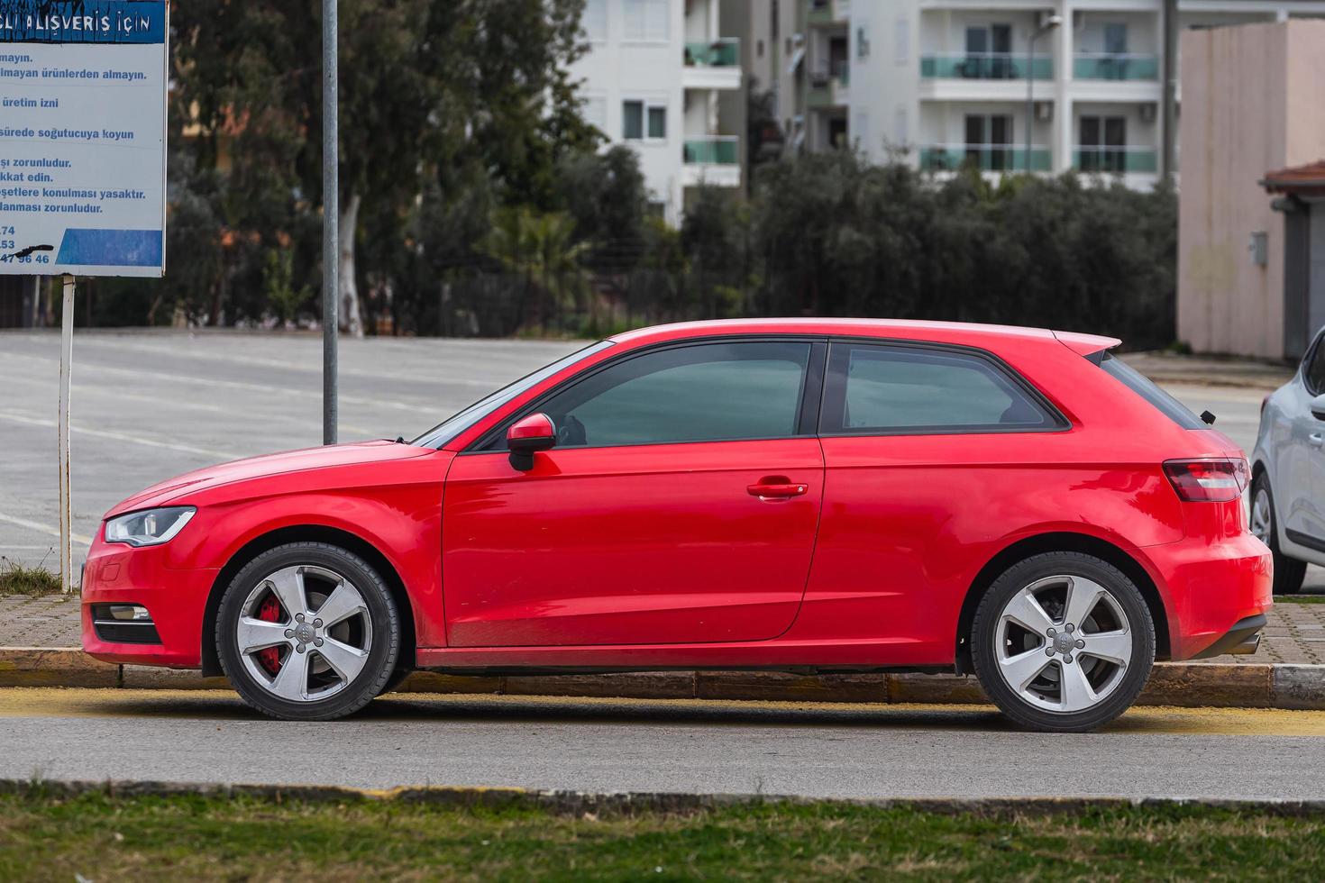 Side Turkey  February  18, 2022  red Audi A3   is parking  on the street on a  summer day photo