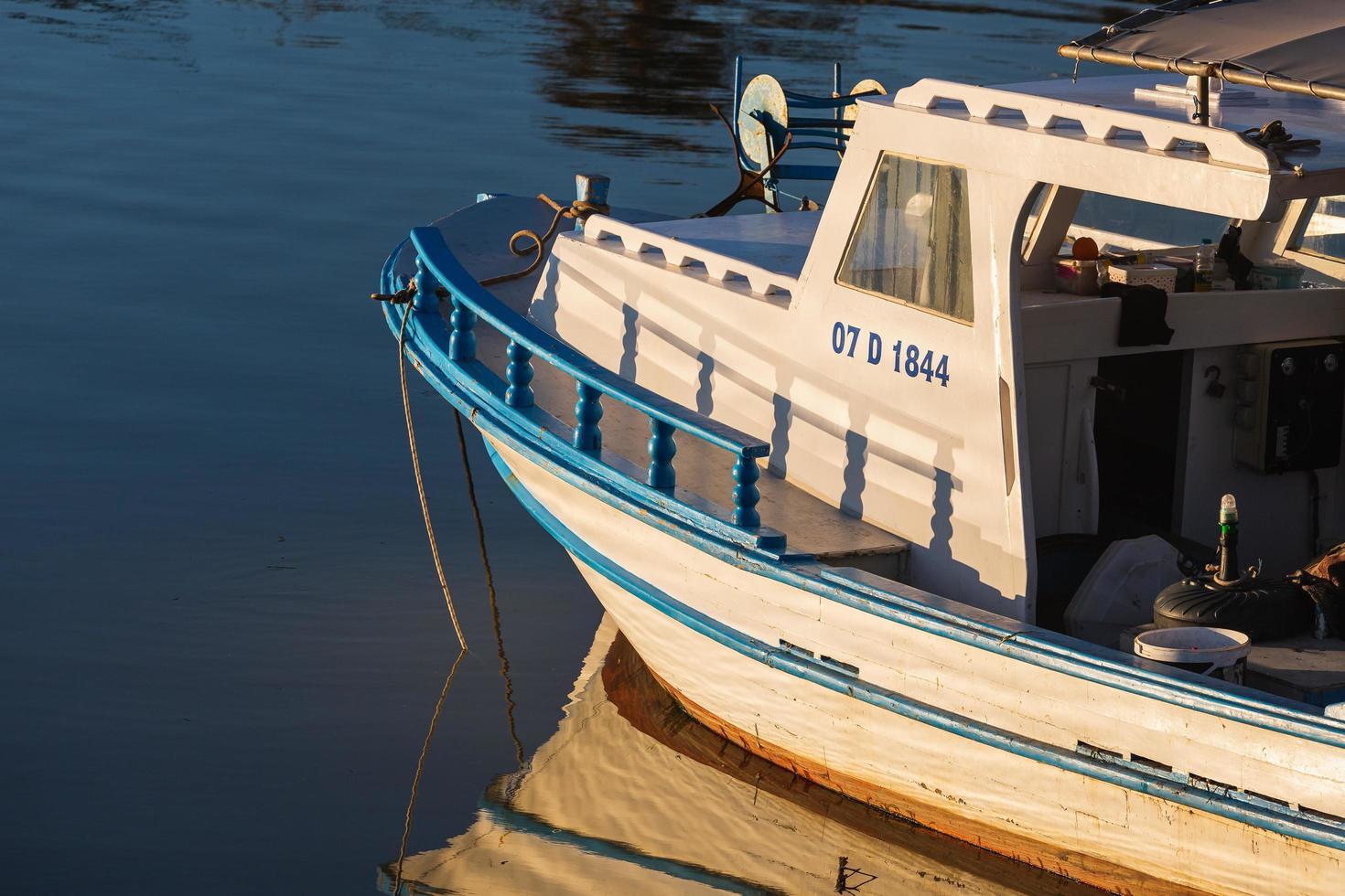 Side Turkey  February 20 2022   Wooden side of the  white boat,  with a beautiful wooden fence and ropes against the background of sea water photo