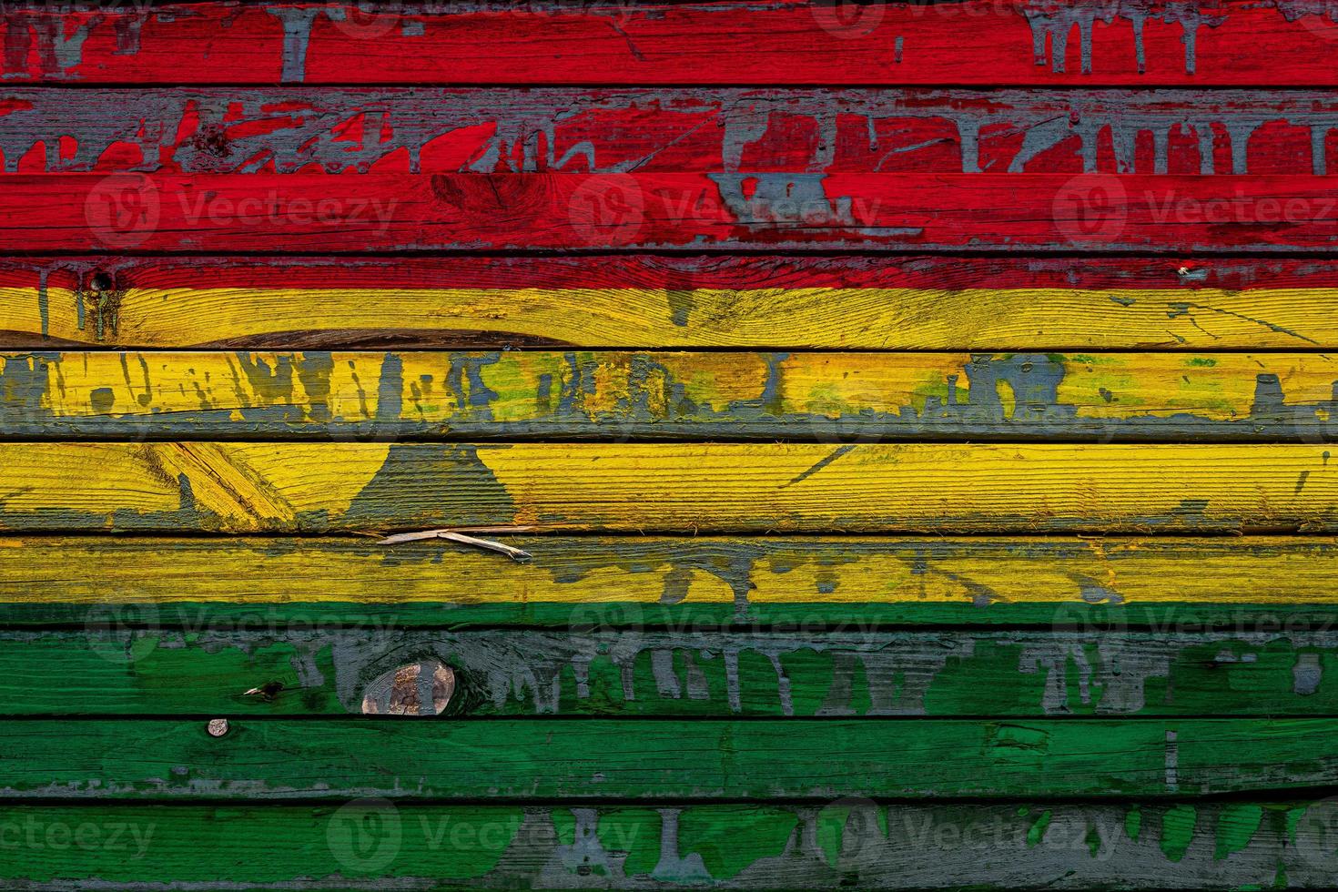 The national flag of Bolivia is painted on uneven boards. Country symbol. photo