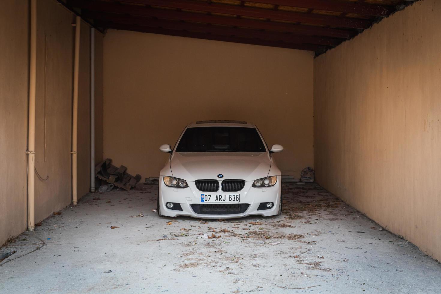 Side  Turkey  February  20, 2022  white BMW 3 series e90 is parked  on garage photo