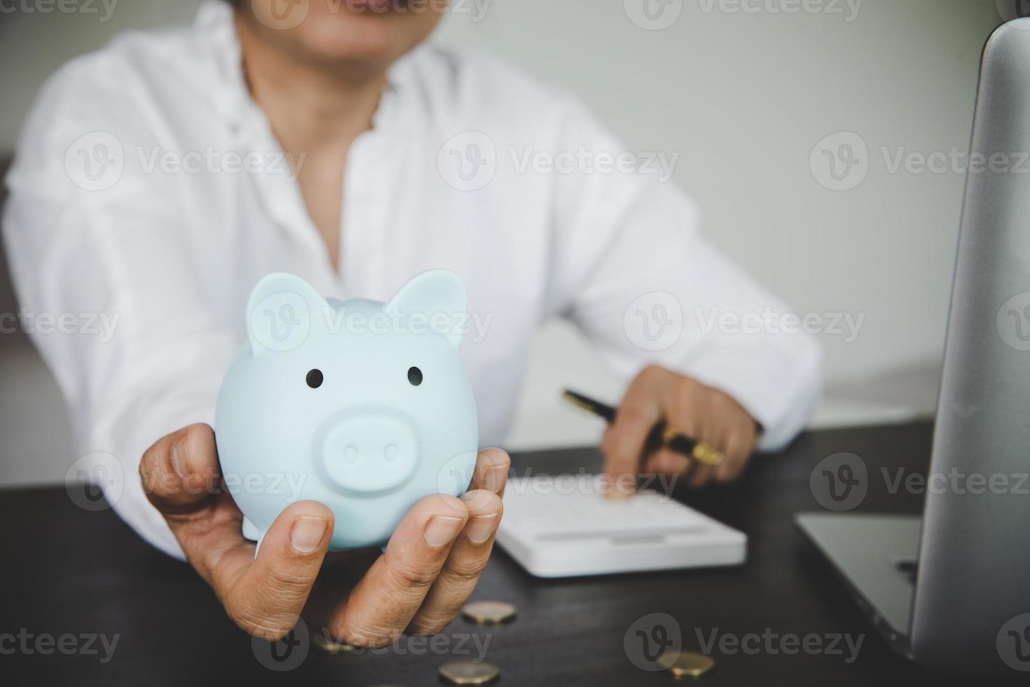 woman hand holding piggy bank photo