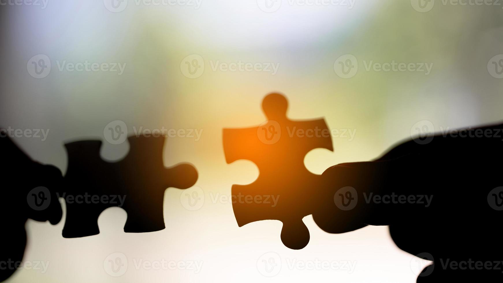 Closeup hand of woman connecting jigsaw puzzle photo