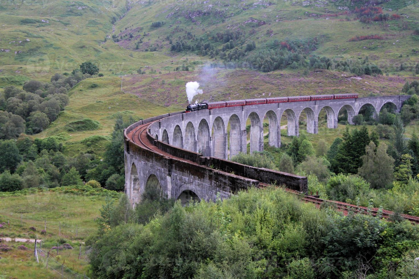 A view of the Glenfinnan Viaduct showing a Steam Train passing over it photo