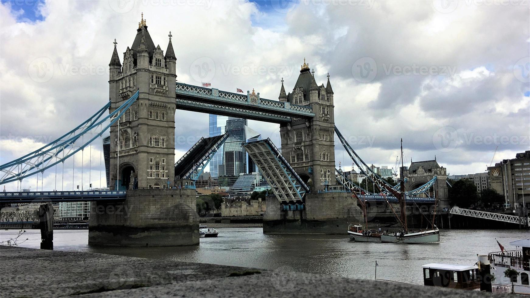 A view of Tower Bridge in London with drawbridge opening photo