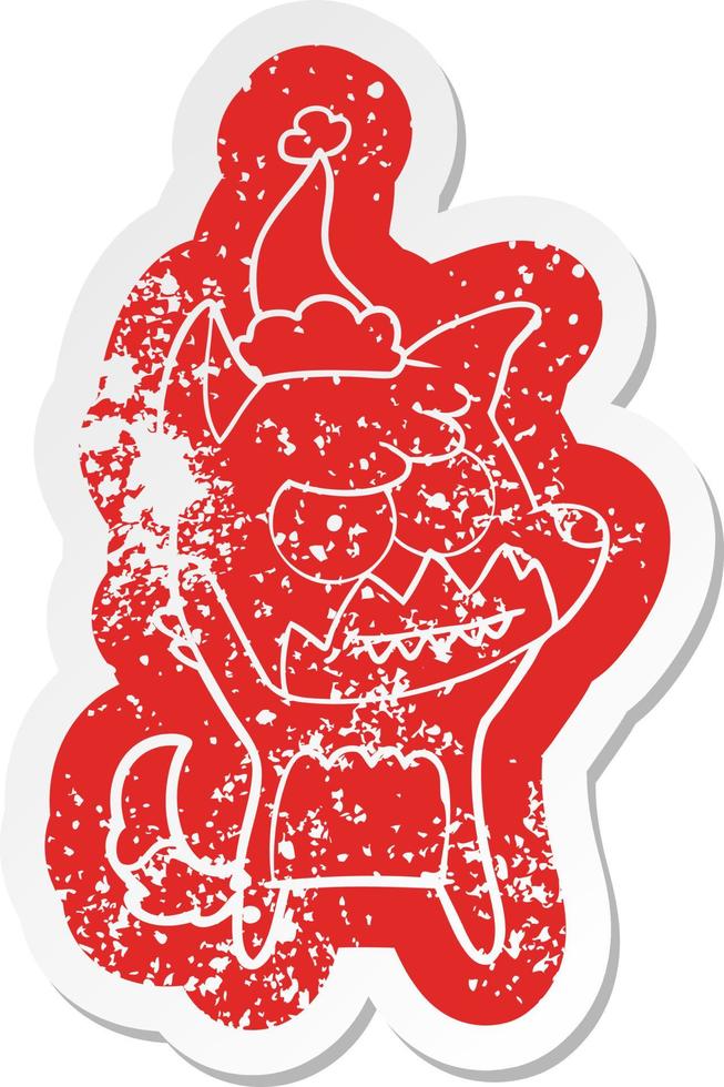 cartoon distressed sticker of a grinning fox wearing santa hat vector