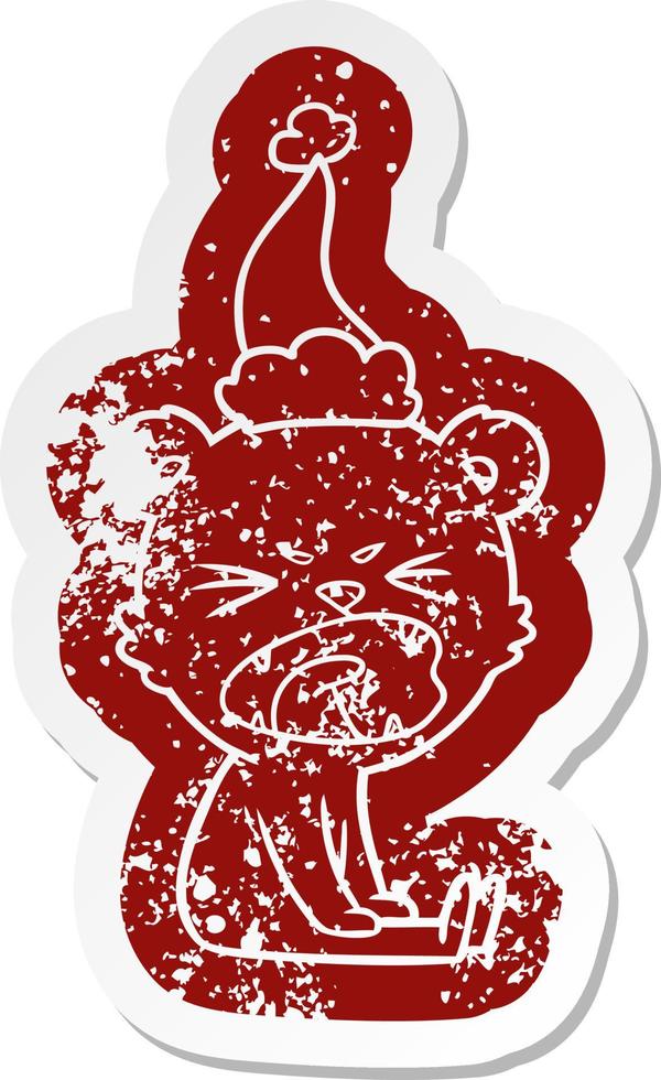 angry cartoon distressed sticker of a bear wearing santa hat vector