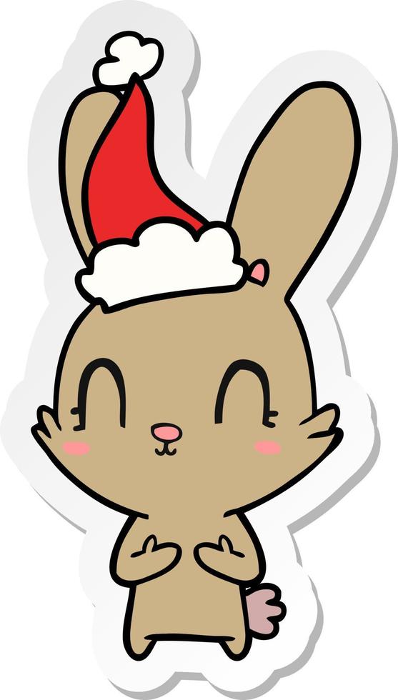 cute sticker cartoon of a rabbit wearing santa hat vector