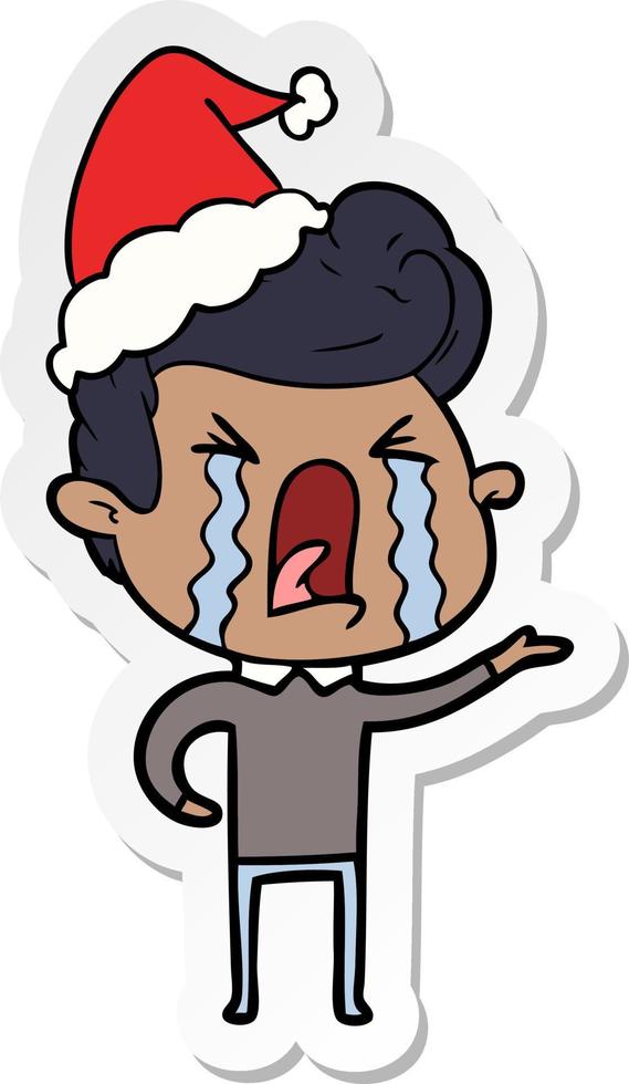 sticker cartoon of a crying man wearing santa hat vector