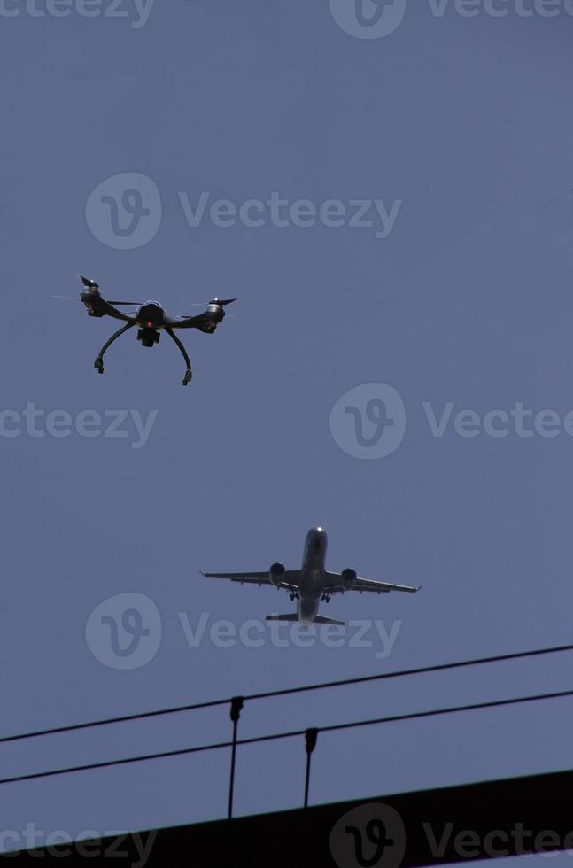 Danger - drone near approaching airplane photo