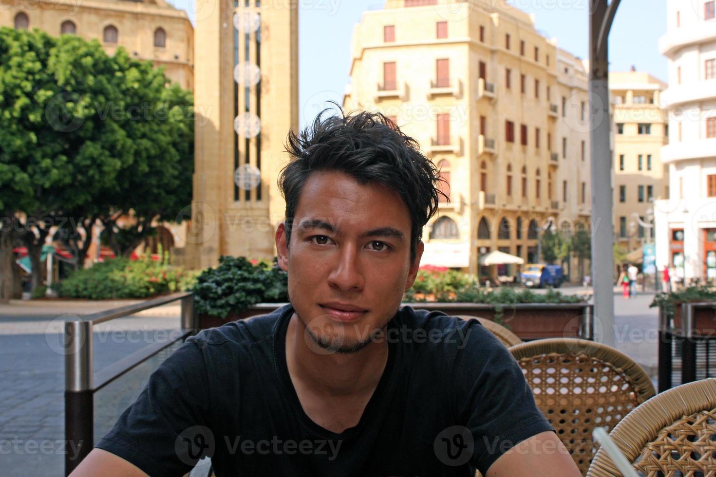 Young man with wild dark hair in a cafe in Beirut, Lebanon photo