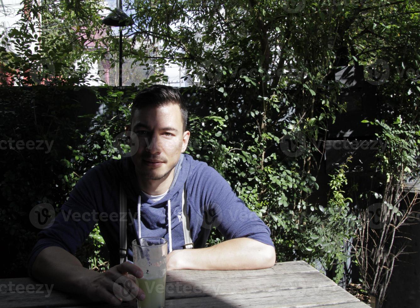 Portrait of a handsome young man with a shadow covering half his face photo