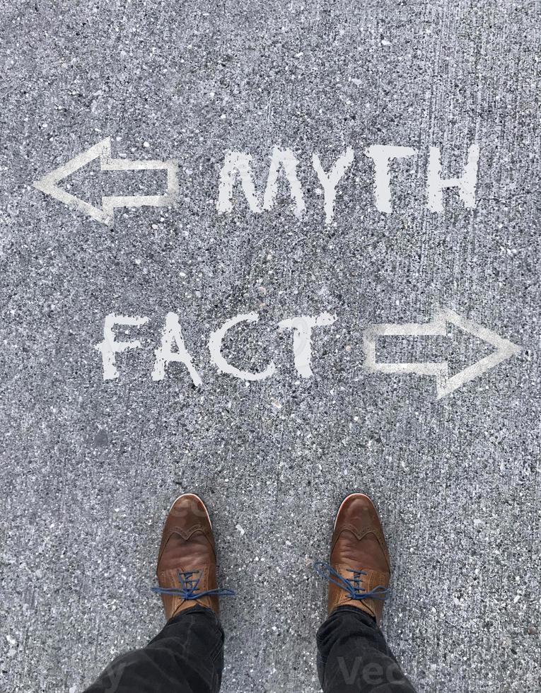 Man standing in front of two arrows and the words Myth and Fact photo