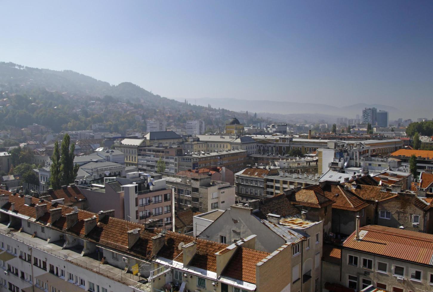 Sarajevo, Bosnia and Herzegovina - June 5, 2022 - Beautiful view over the city of Sarajevo with hills in the background on a sunny day. photo