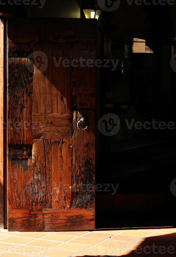 Old wooden door of South African house in the afternoon sun photo