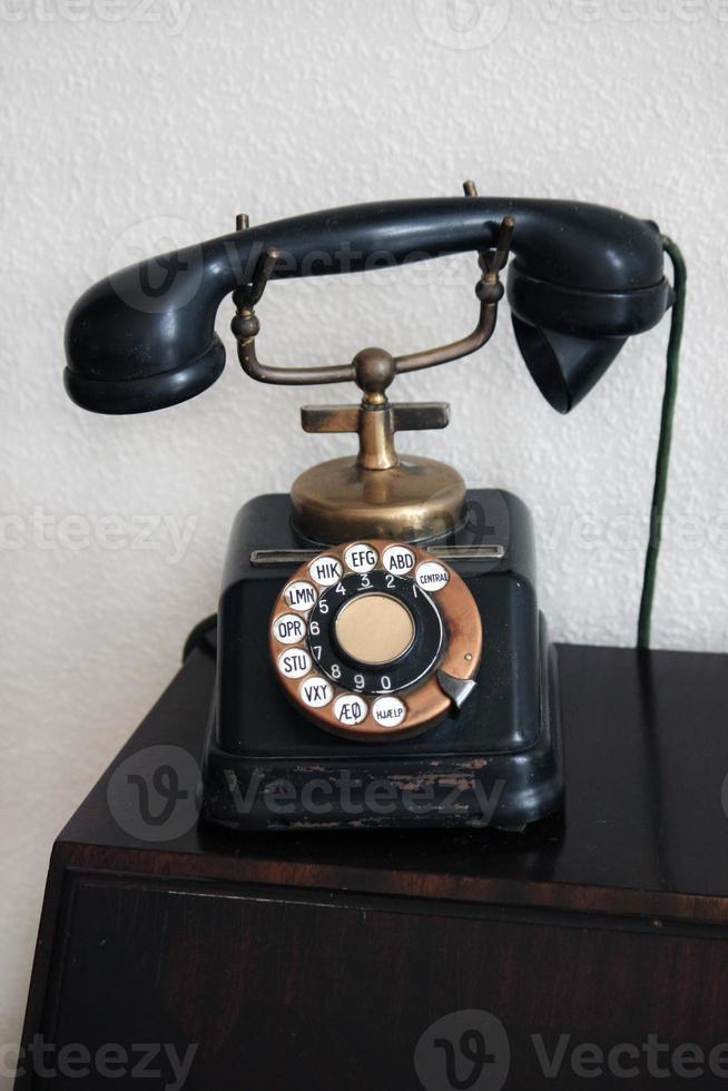 Old telephone with dial disk photo