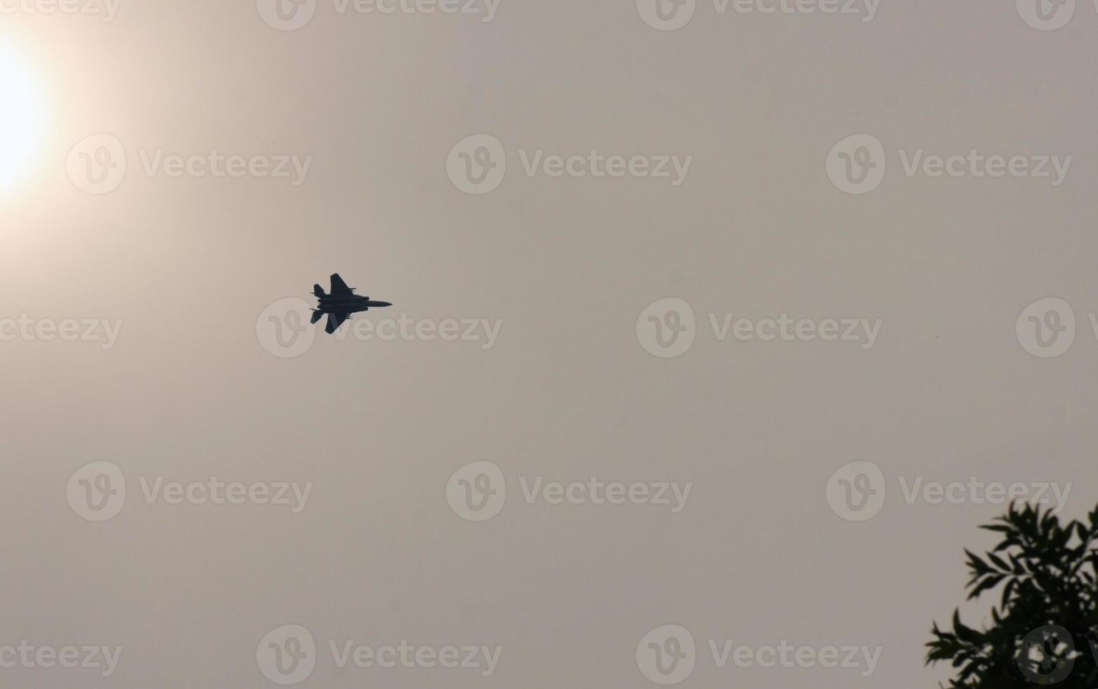 Fighter jet flying past the sun in Japan photo