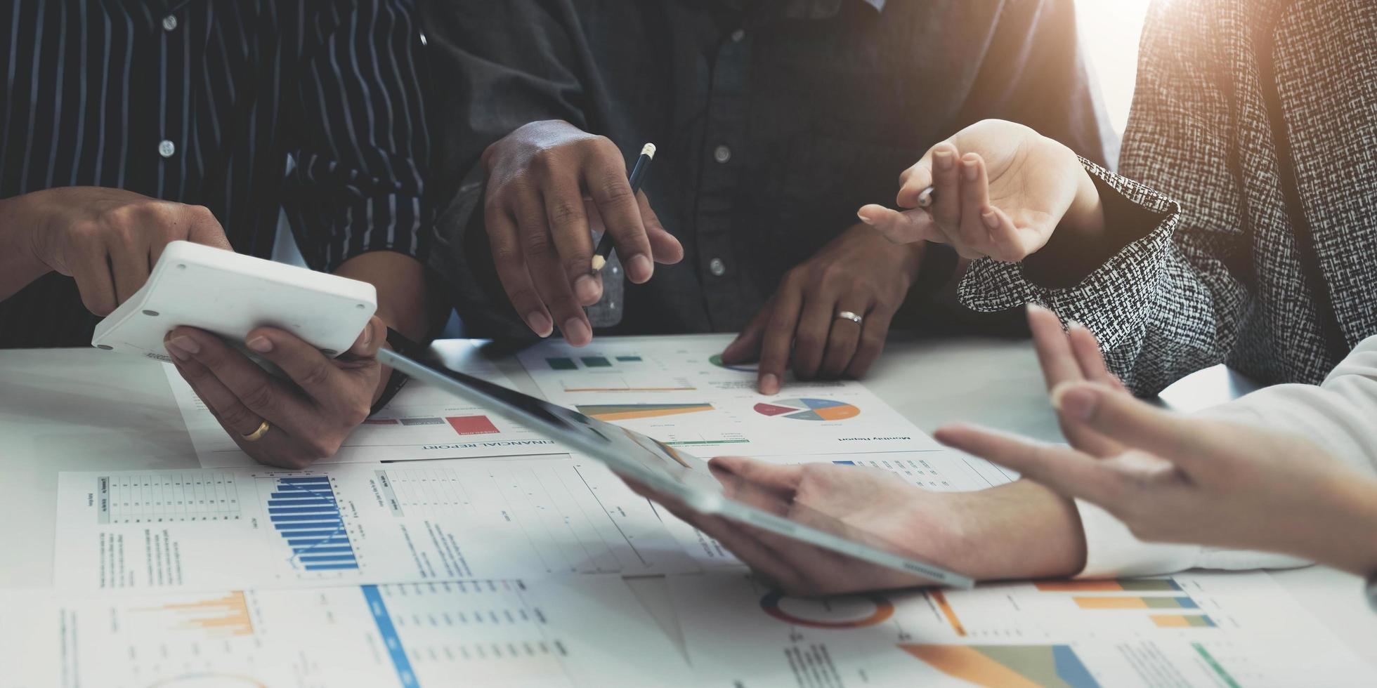 Group of business people meeting together Pointing to the graph assess business profits. photo