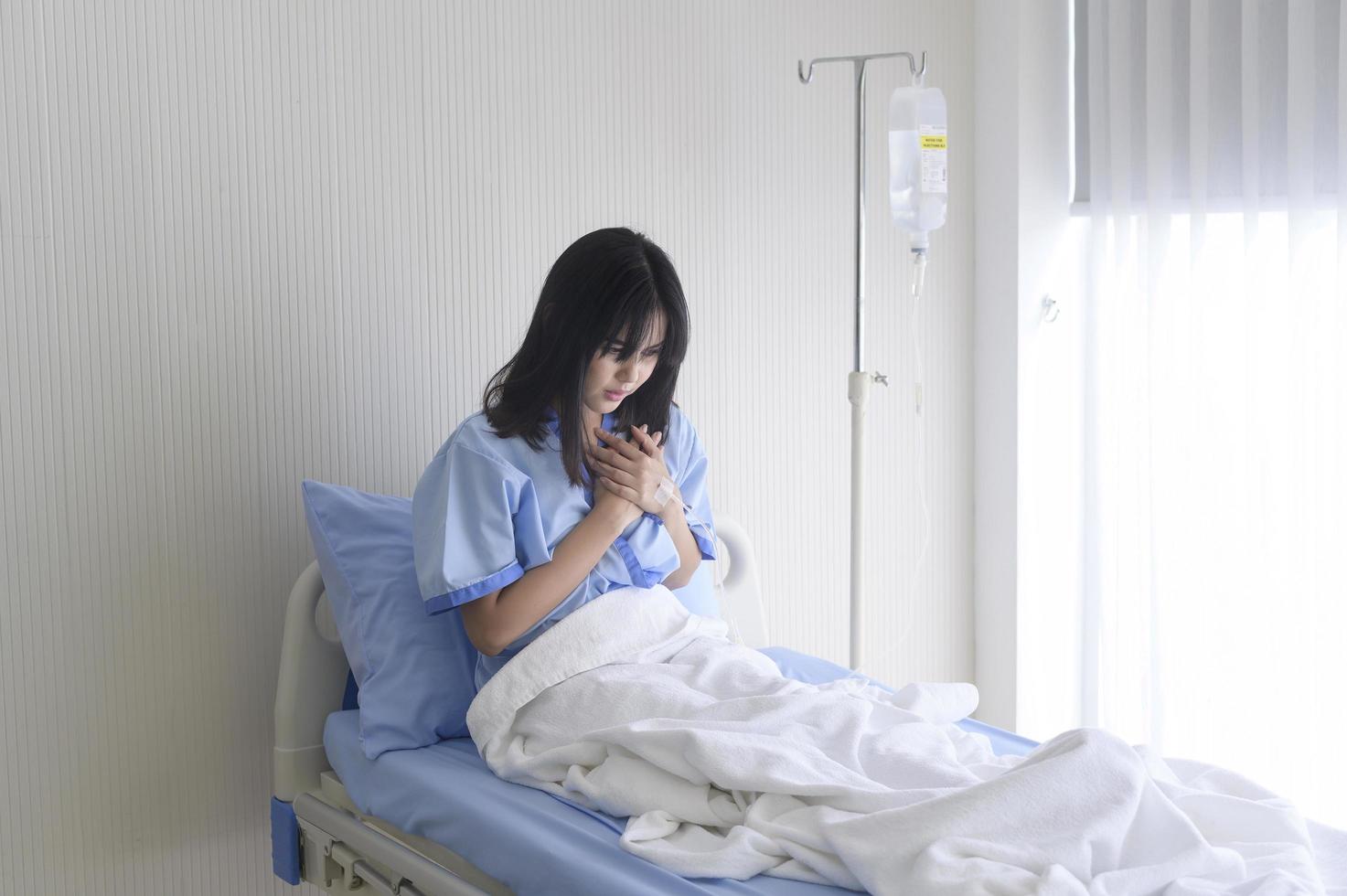 A despondent Asian woman patient. Following the doctor's declaration that the cancer was nearing the end of its course. photo