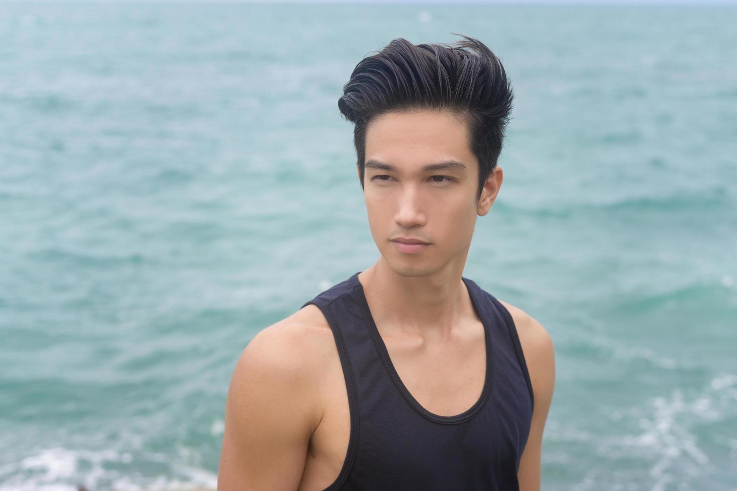 Portrait of smiling male tourist on the seaside, nature tourism concept photo