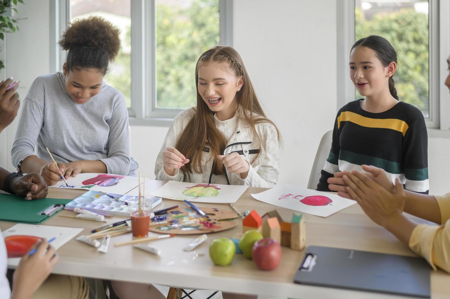 group of students studying and playing with teacher, education and learning concept. photo