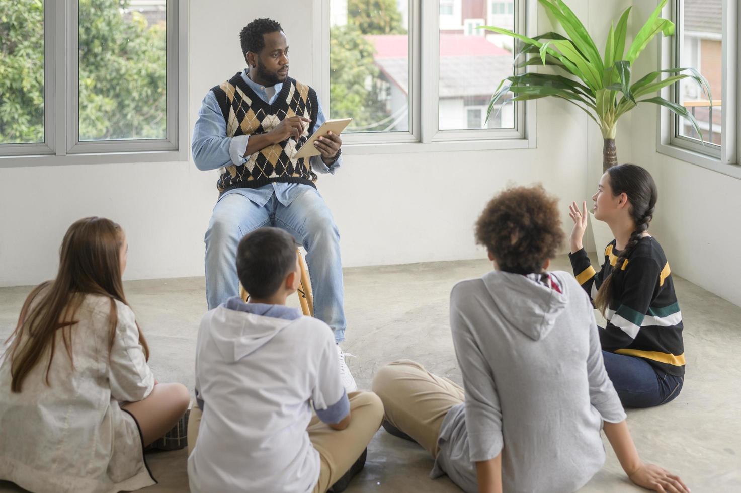 group of students studying and playing with teacher, education and learning concept. photo