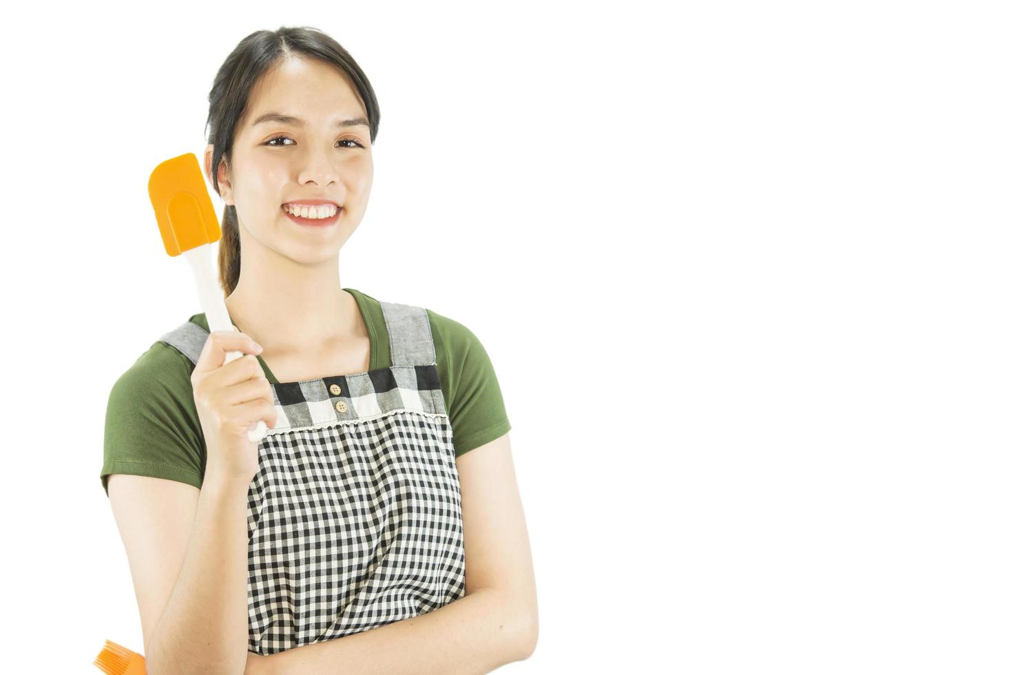 Happy lady holding kichen stuff over copy space background - people home made food preparation concept photo