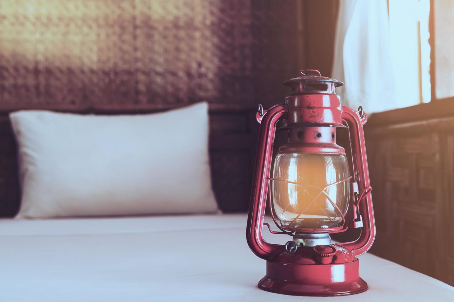 Old lantern on white bed in native local resort without electricity in Thailand - conservation local travel resort concept photo