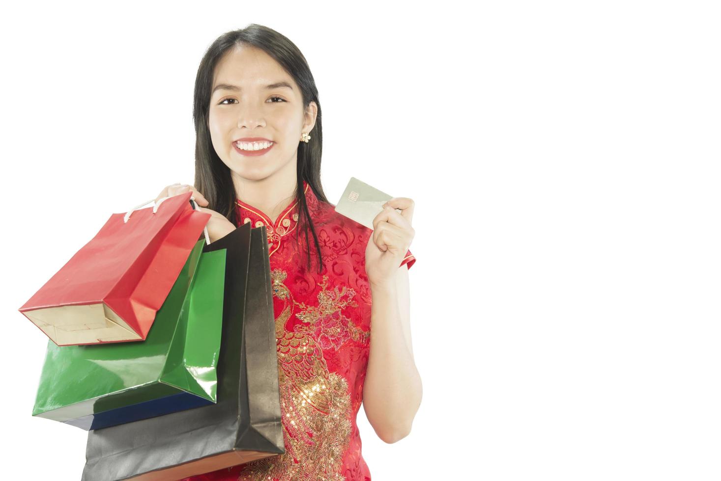 Happy Asian lady shopping in Chinese suite isolated over white copy space - woman day concept photo