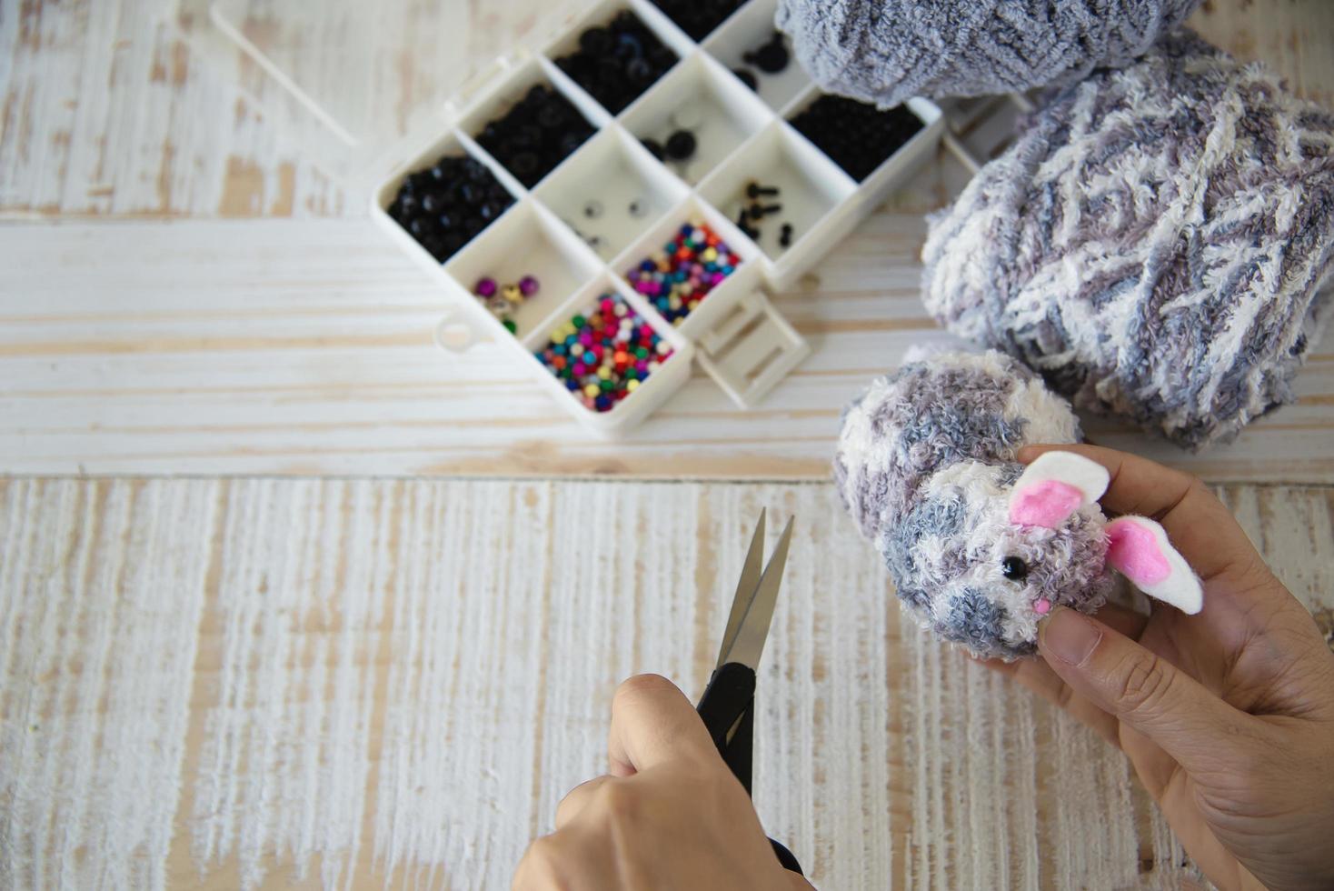 Woman making lovely bunny doll from yarn  - Easter holiday celebration concept photo