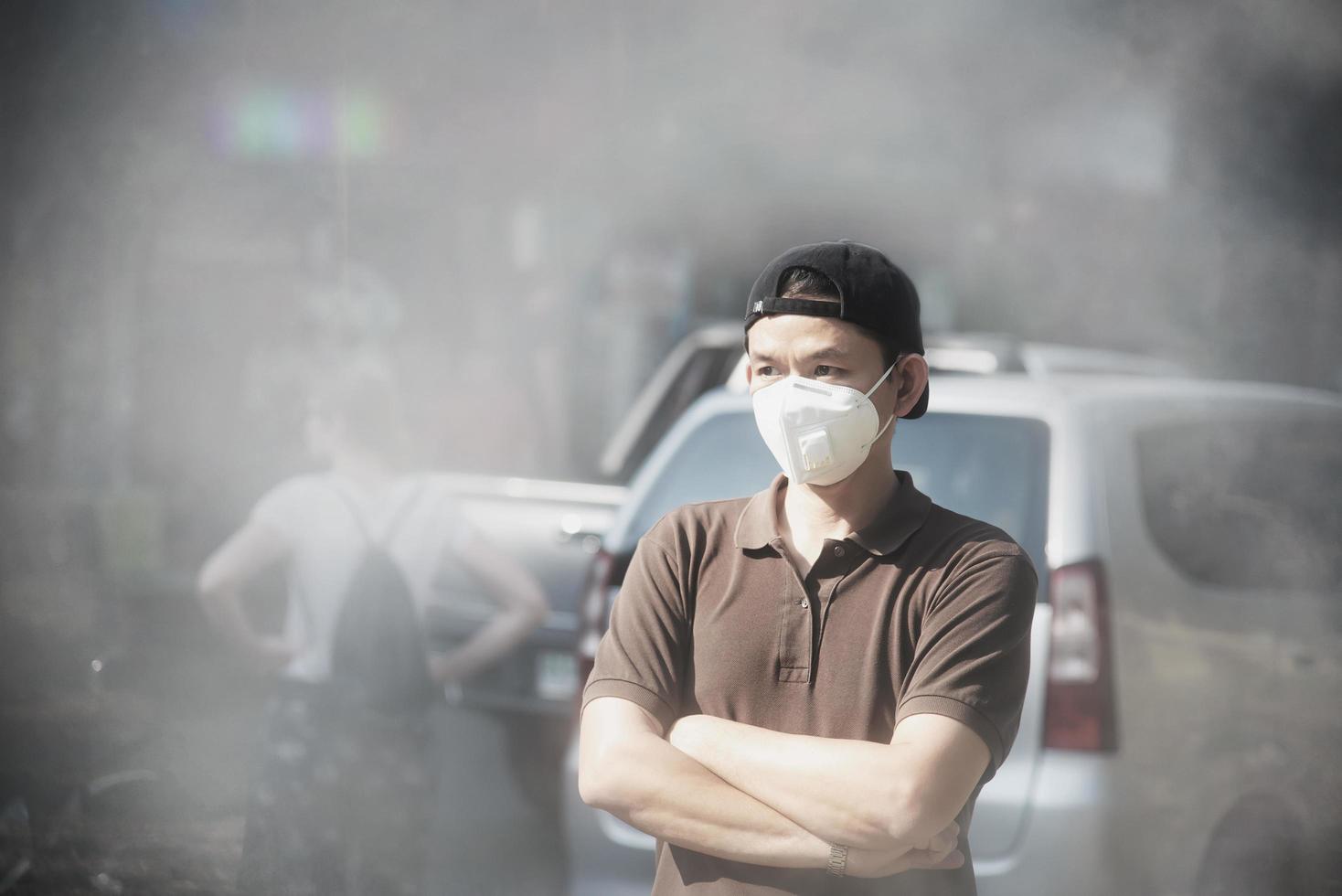 Man wearing mask protect fine dust in air pollution environment - people with protection equipment for air pollution concept photo