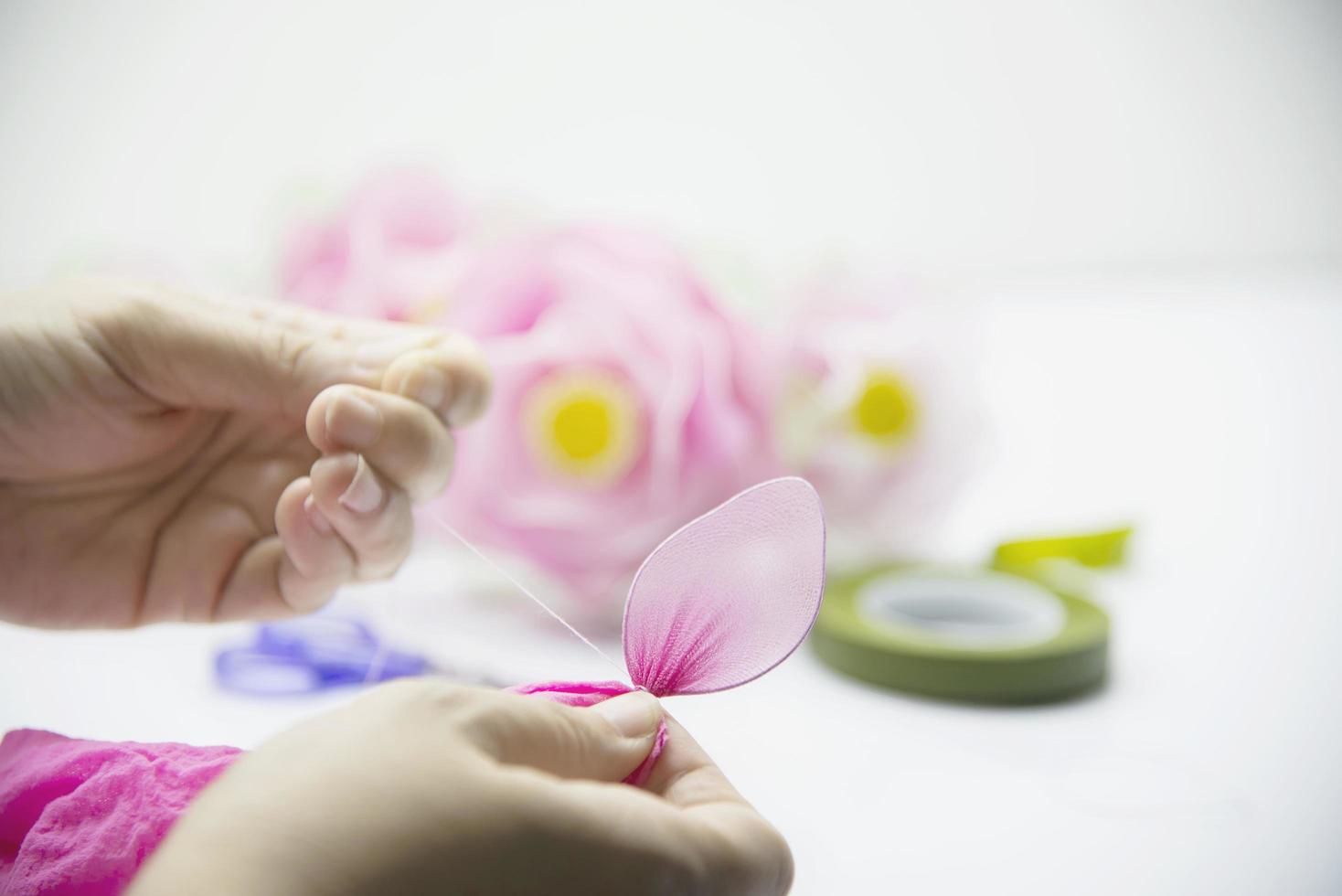 Woman making beautiful nylon flower - people with DIY handmade flower concept photo