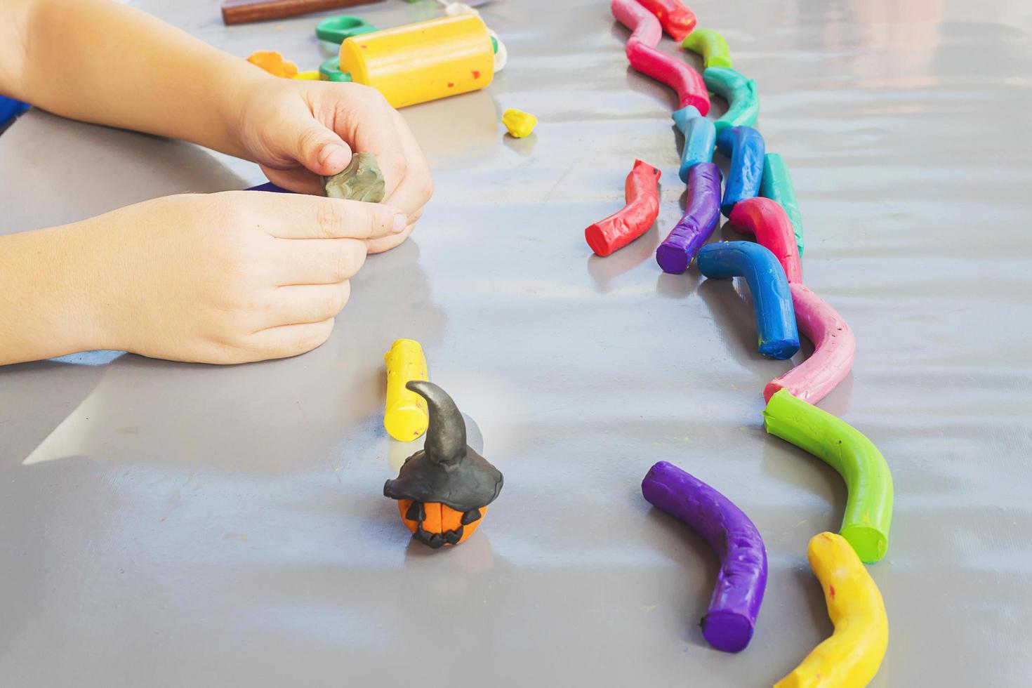 Boy is happily playing clay toy photo