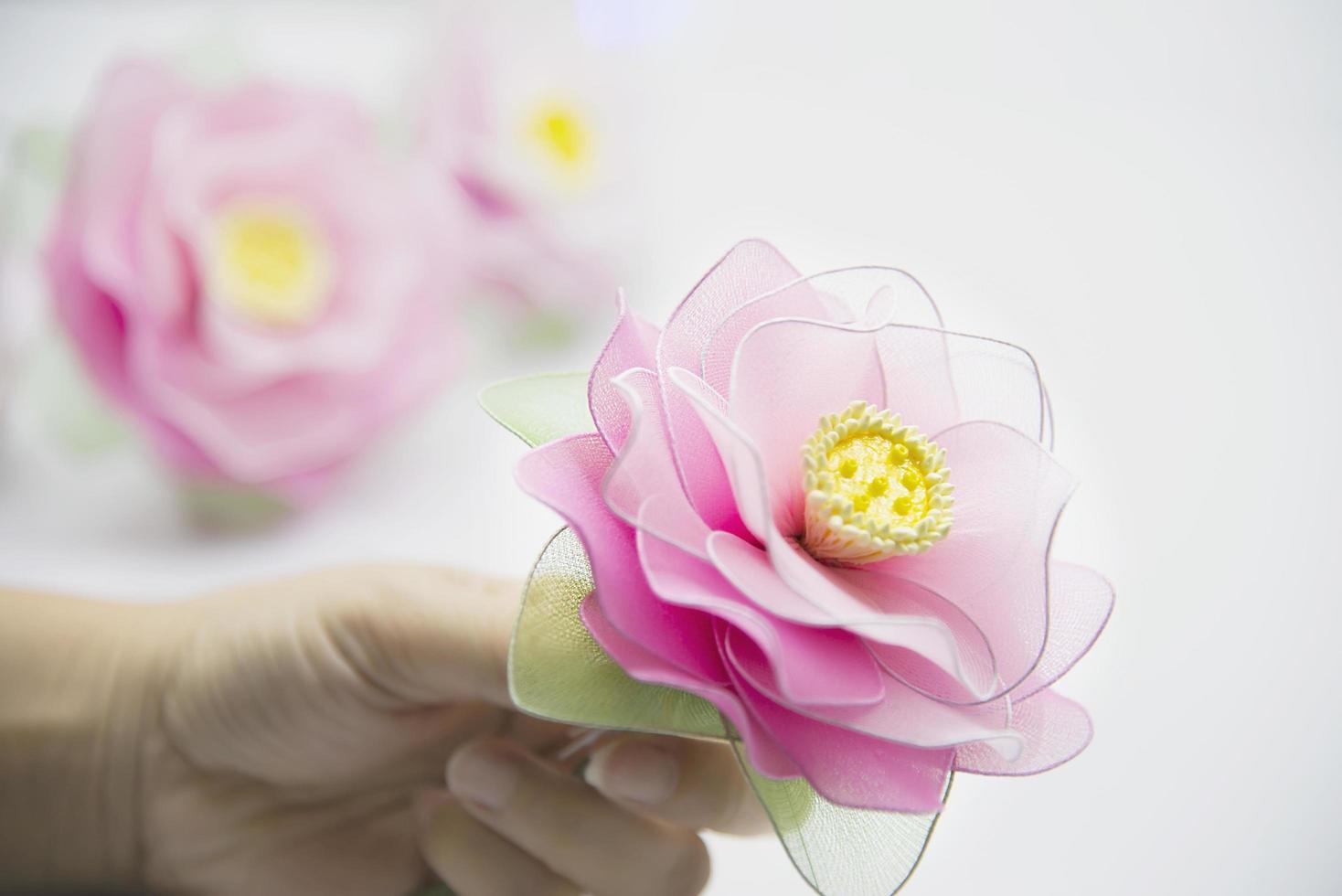 Woman making beautiful nylon flower - people with DIY handmade flower concept photo