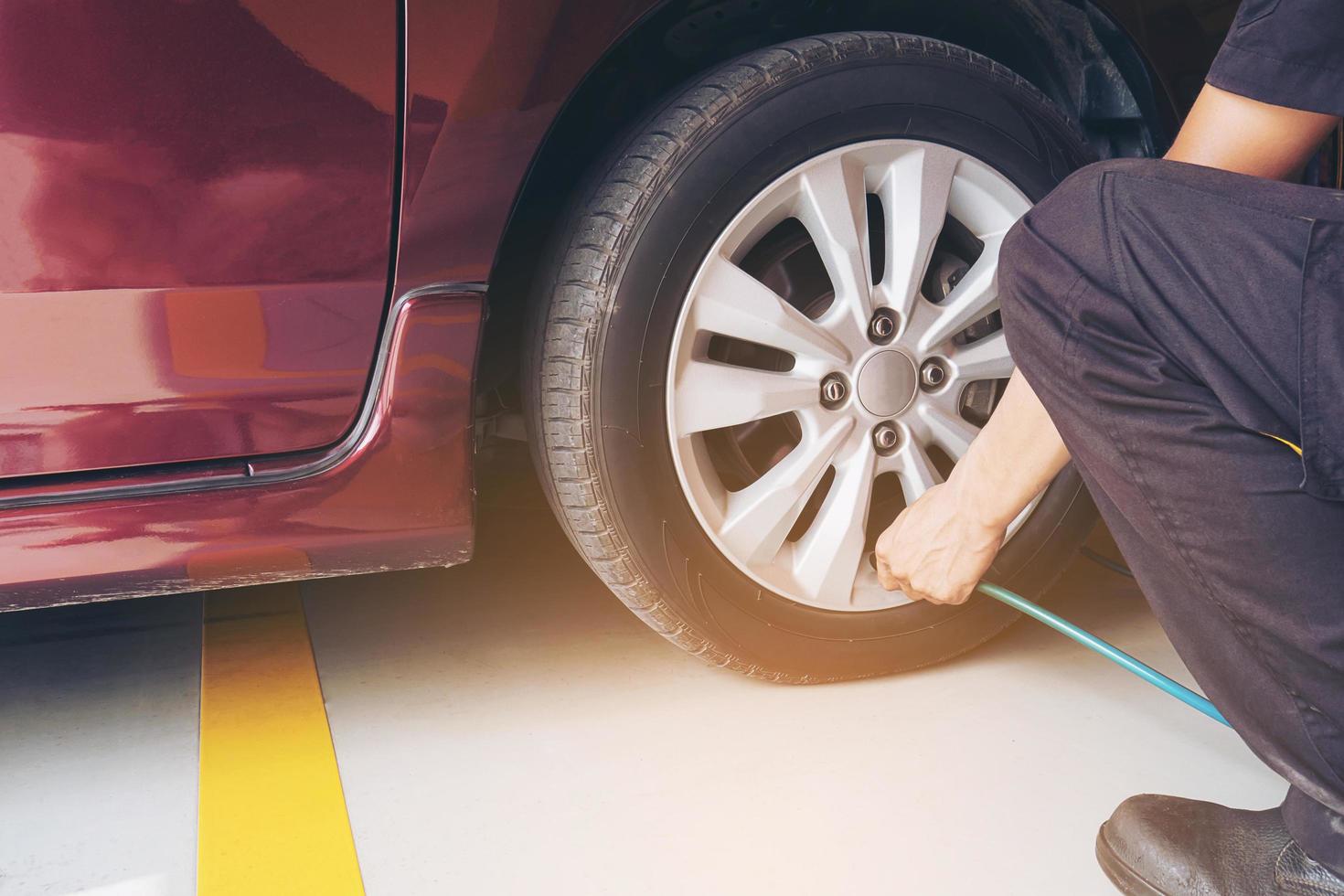 Technician is inflate car tire - car maintenance service transportation safety concept photo