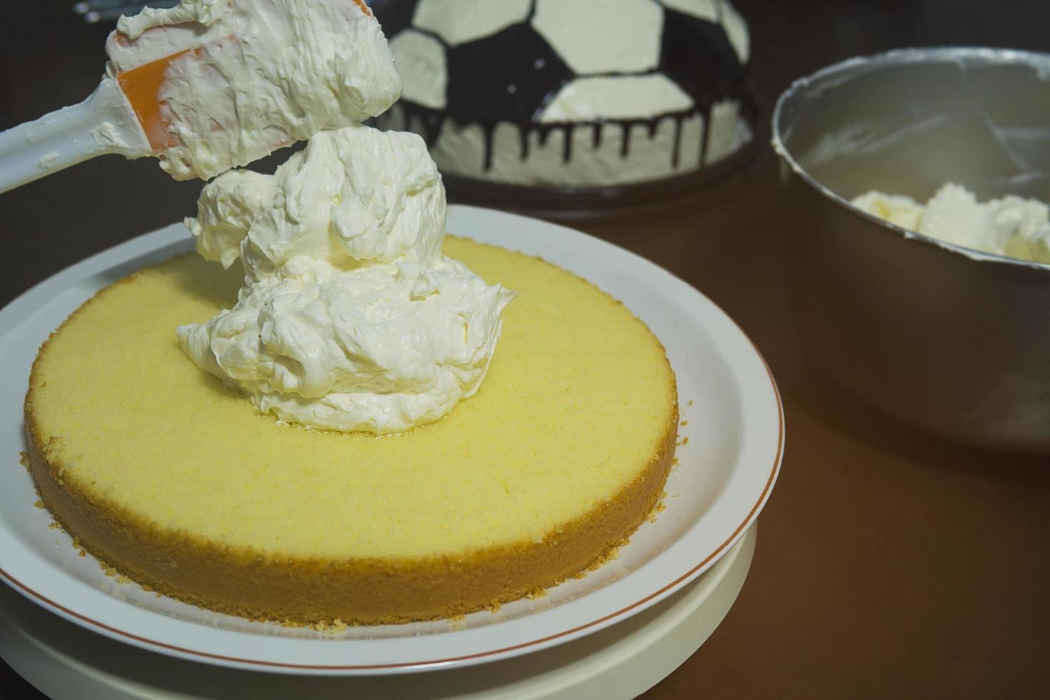 Putting butter  cream cake by hand using spatula photo